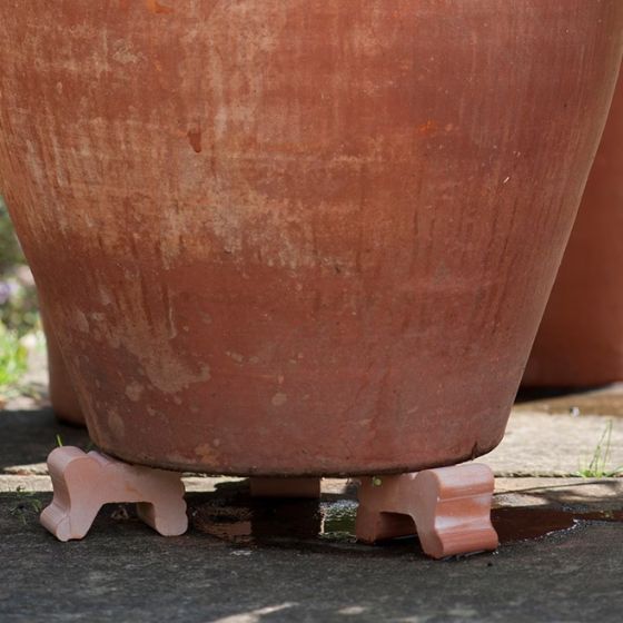 pot feet under a terracotta pot
