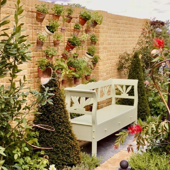 brick wall with terracotta plant pots traditional style