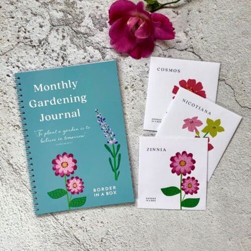 monthly garden journal with three packets of flower seeds