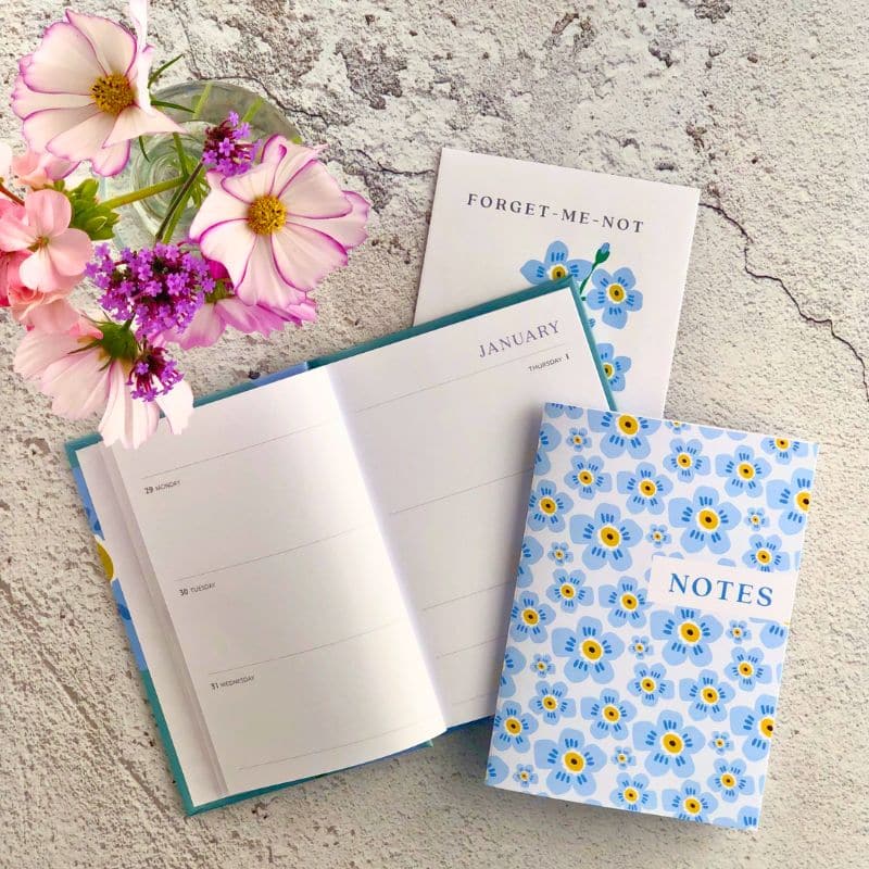 pocket diary, forget me not seeds and notebook