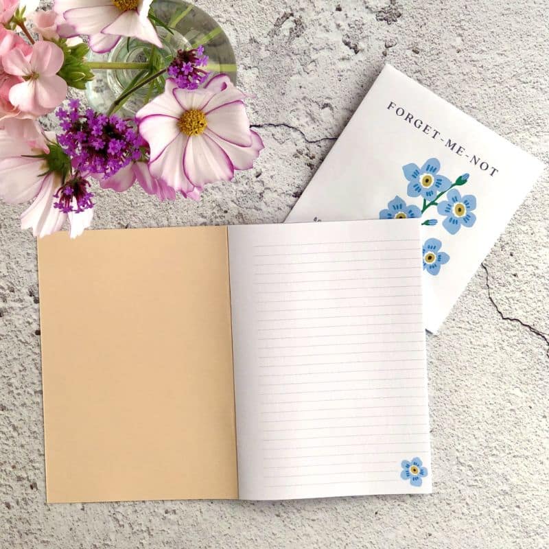 A6 notebook with forget me not floral design and seeds